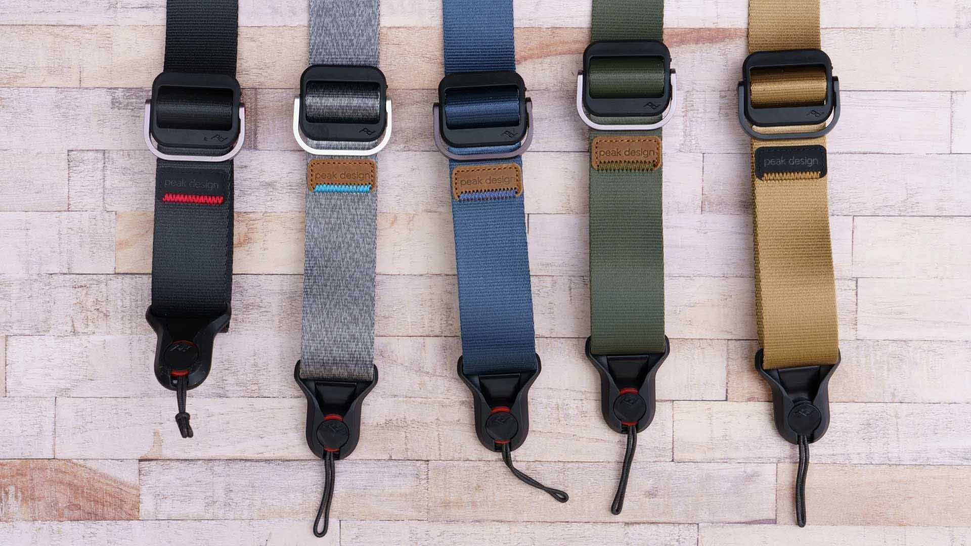  From left to right, the Peak Design Slide Lite is available in Black, Ash, Midnight, Sage and Coyote. 