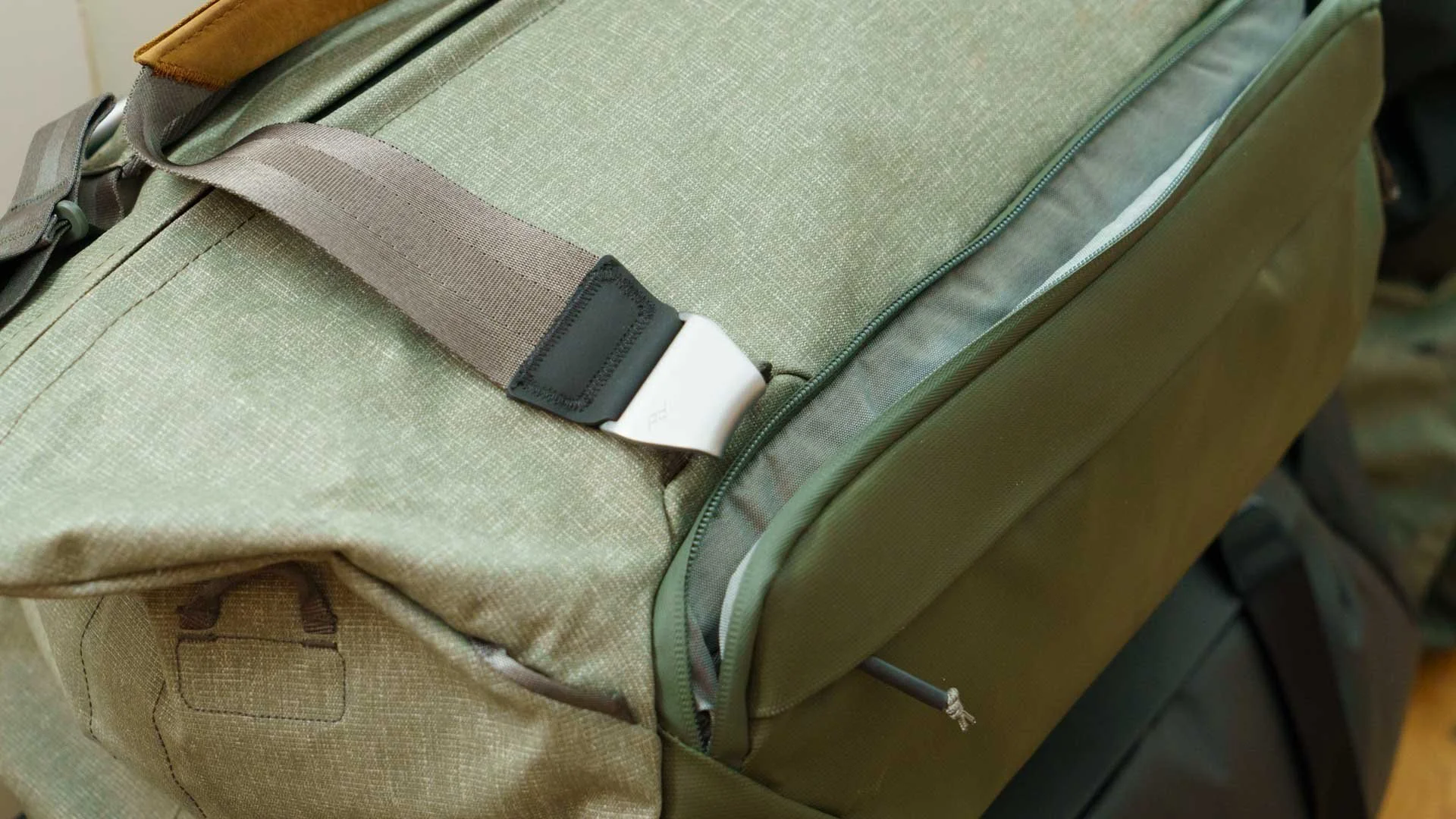  There are two long zippered pockets on either side of the Peak Design Travel Duffel bags. This images shows the larger of the two open, the smaller one is just below it. 