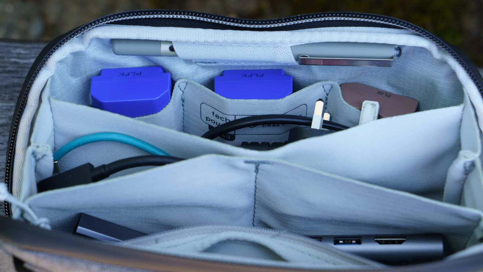 The Peak design Small tech Pouch has three pockets that are useful for storing camera batteries.