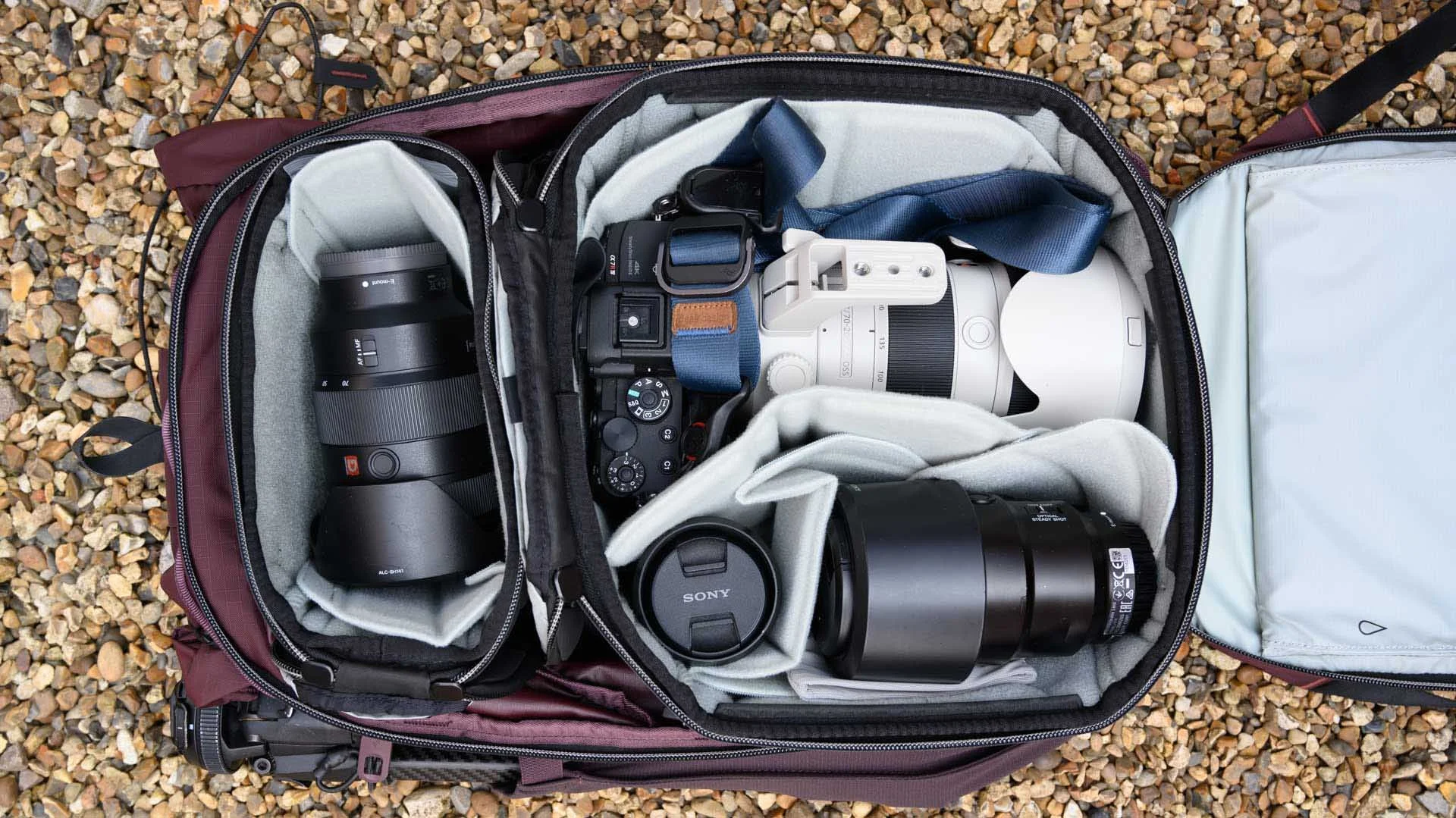 The main compartment of the Peak Design Outdoor Backpack 25L can accommodate an SMedium Camera Cube (right) and an XS Camera Cube.