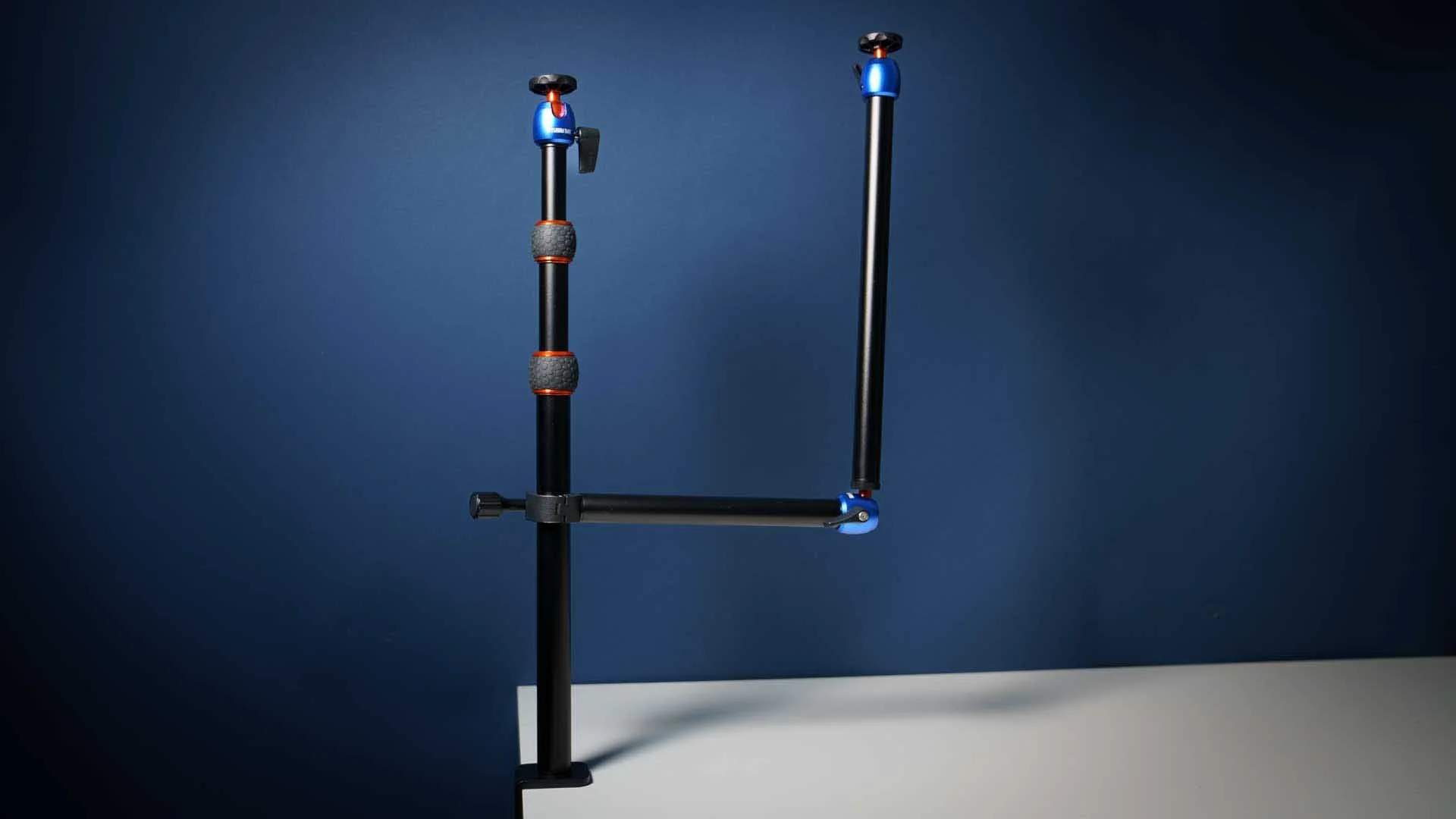  This images shows the 3 Legged Thing Camera Desk Mount System Kit 2A. Kit 1A includes just the main vertical pole with its table clamp and mini ball head on the left of the image. Kit 1A adds the side arm - the vertical section in this image, and the Kit 2A adds the vertical section with ball head on the right. 