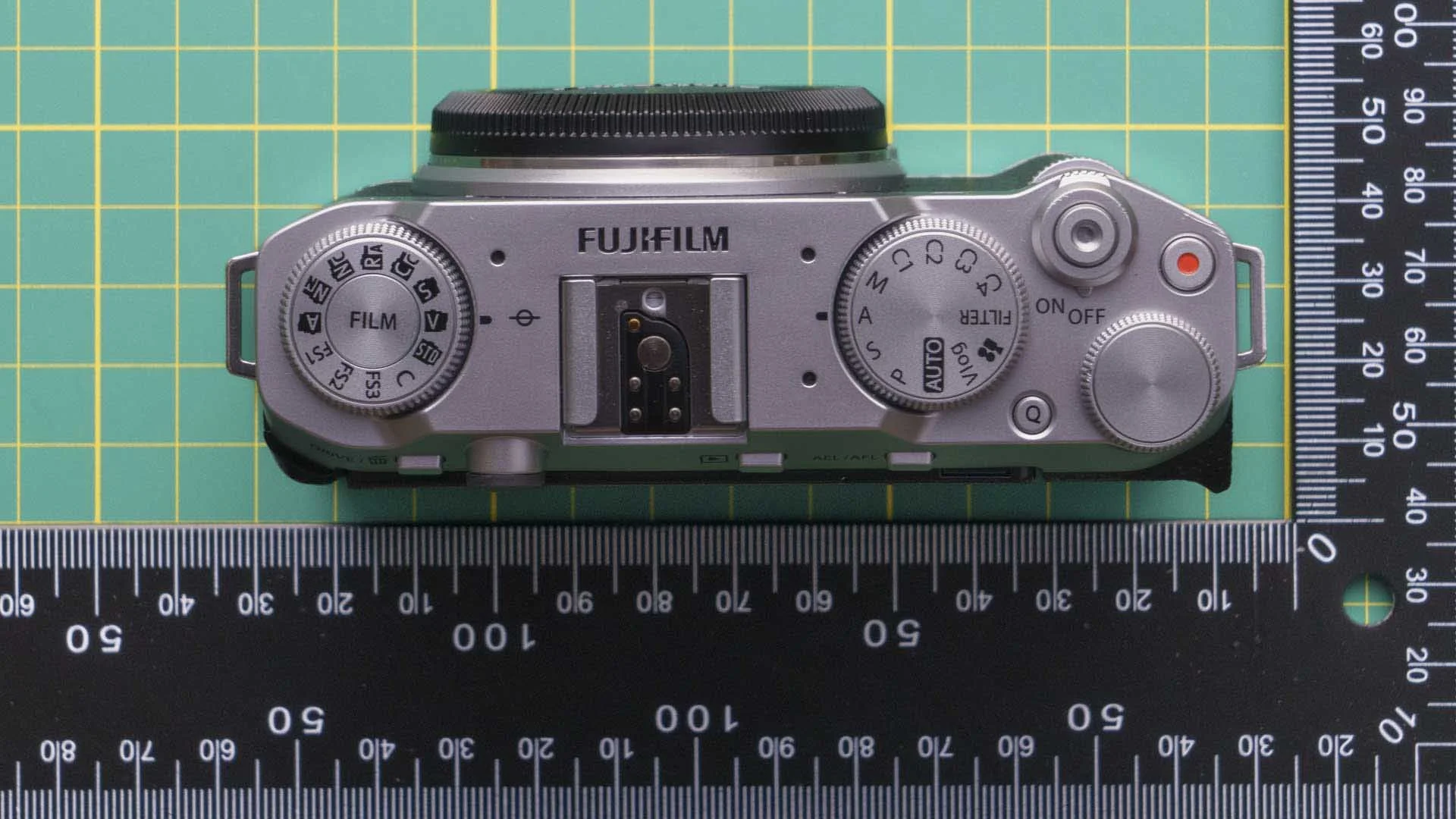  The Fujifilm X-M5 has a dial for setting the Film Simulation Mode, an exposure mode dial and two control dials. The first control dial is on the extreme right of the top plate while the second protrudes from the front of the camera just below the power switch and shutter button. The small thumb rest is visible on the bottom-right corner of the camera in this image. 