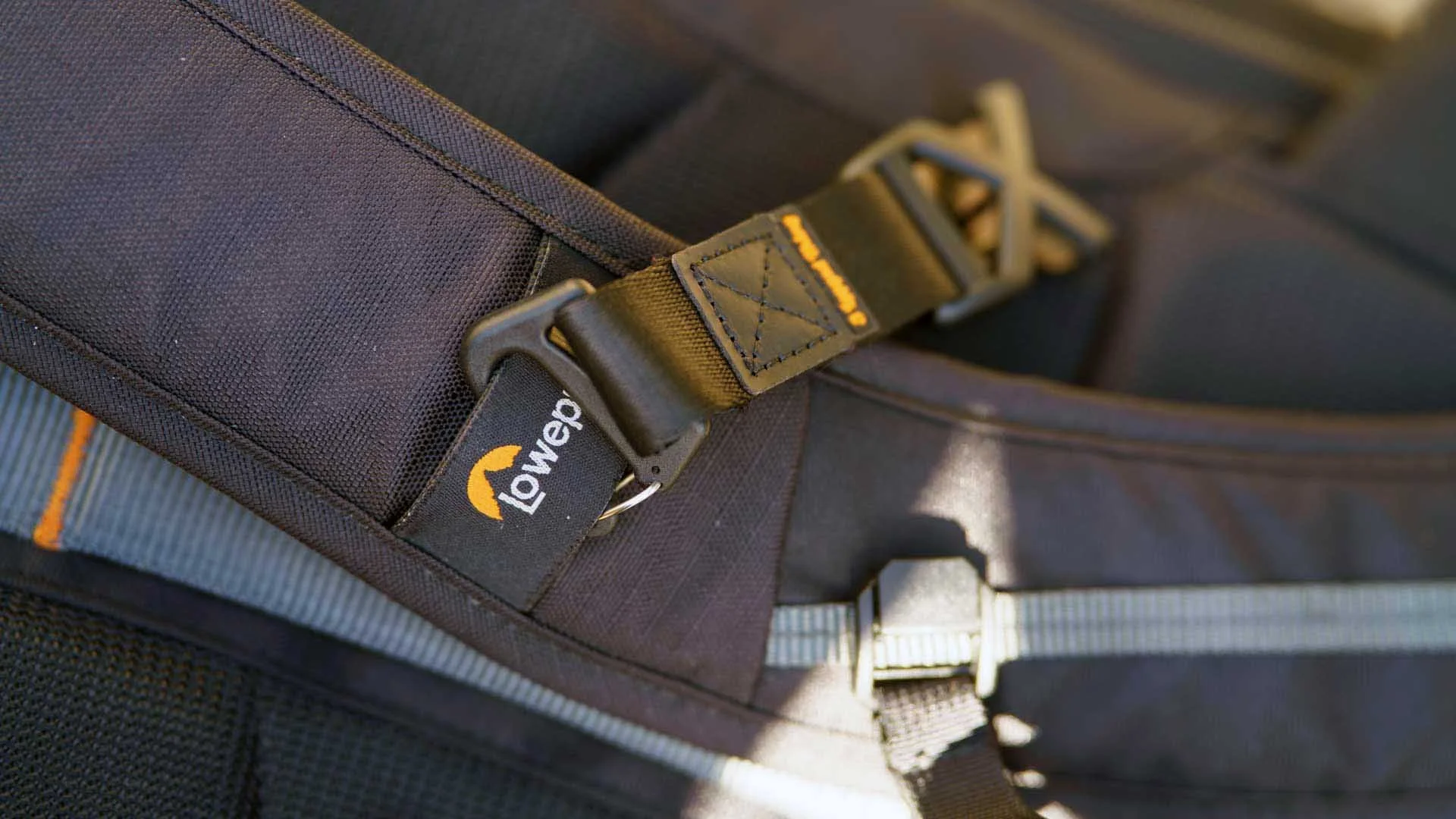 The clips that attach the Axis Anywhere to a a backpack are tough and secure. Once they are in place, you can remove the main section of the strap quickly by undoing the snap-fasteners at either end. 