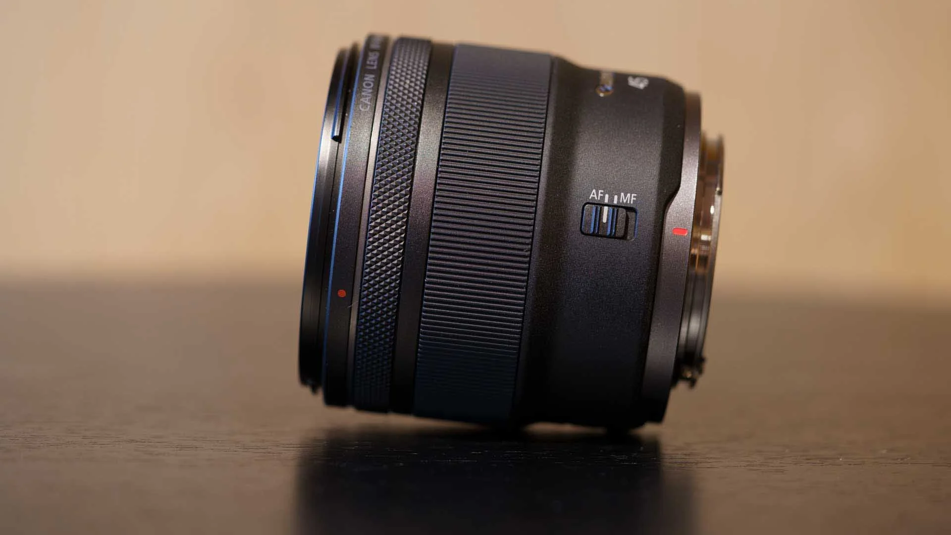  A side view of the Canon RF 45mm F1.2 STM showing the AF/MF switch and lens rings. The narrow knurled ring is the customisable control ring while the ridge ring is for manual focusing.  