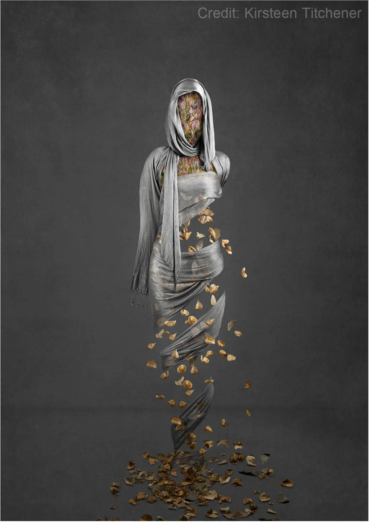 Abstract image of a figure wrapped in gray fabric, with colorful floral patterns as the head and torso, surrounded by floating petals on a dark background. Credit: Kirsteen Titchener.