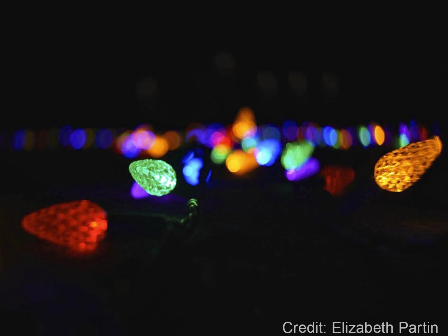 Colorful LED string lights glowing in the dark