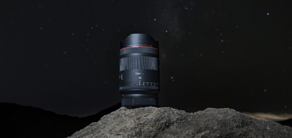 Canon RF 14mm F1.4L VCM on a rock at night with stars behind