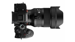 Top-down view of a Sony mirrorless camera fitted with a Sigma 35mm F1.4 DG II | Art lens and petal-shaped hood. Lens barrel markings read “35mm 1:1.4 DG II Ø67” and “SIGMA,” with visible aperture ring and AF/MF switch.