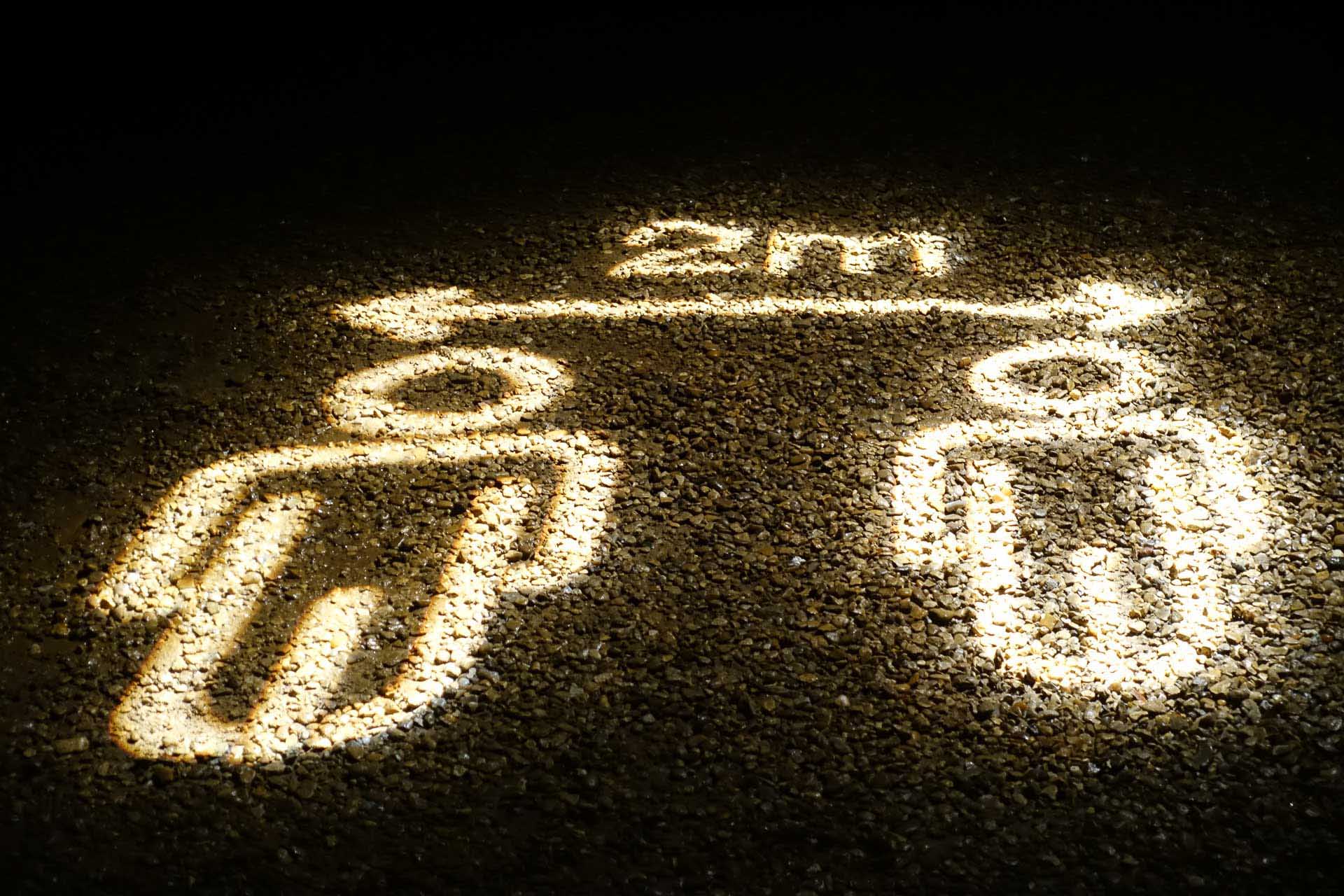 Glowing area of a dark gravel surface with “2m” and two figures marked within the illuminated area