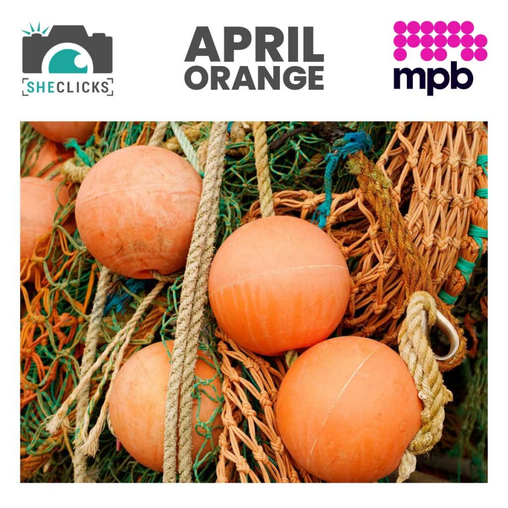 Logos for SheClicks and MPB either side of the words 'April Orange' above a close-up photo of orange fishing buoys tangled in nets and ropes