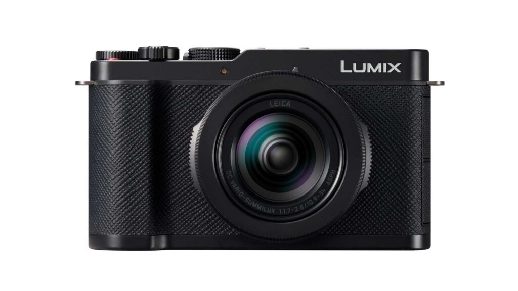 Front view of a black Panasonic Lumix L10 compact camera with a Leica lens against a light white background.