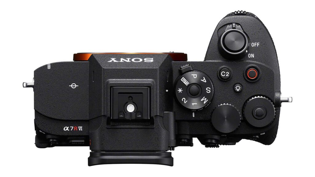 Top-down view of the Sony A7R VI camera body highlighting the mode dial, shutter button, hot shoe mount, and control dials on a light gray background.