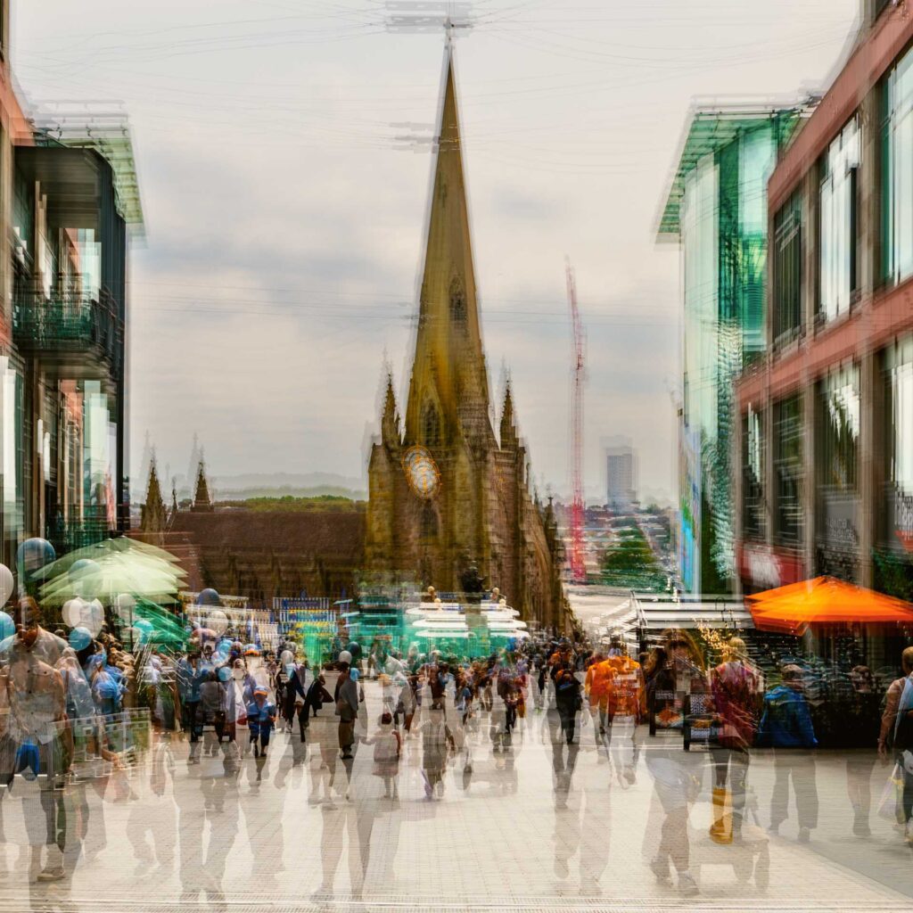 Multiple-exposure city street scene with pedestrians, a church spire, and modern buildings layered together through camera movement.