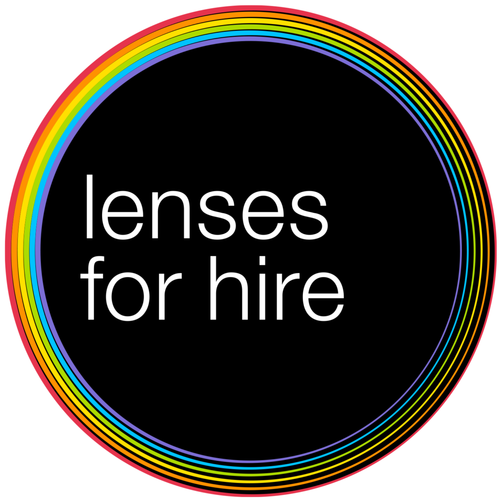 Lenses for Hire circular logo with rainbow colours around the outside, a black centre and the words lenses for hire