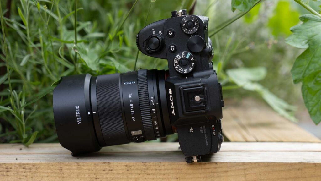 Viltrox AF 35mm F1.8 II FE lens mounted on a Sony Alpha camera, shown from the side with the lens hood attached.