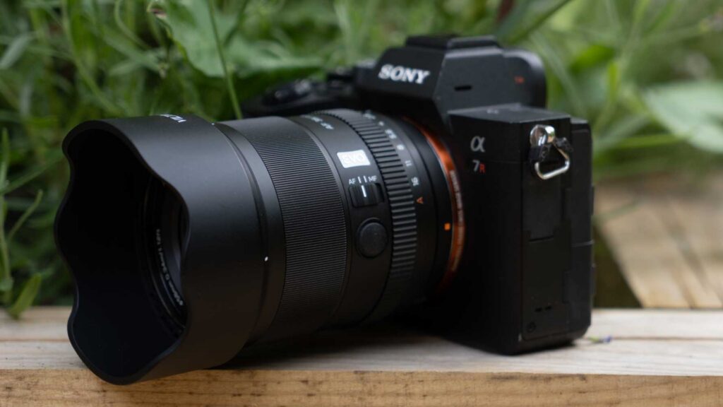 Three-quarter front view of the Viltrox AF 35mm F1.8 II FE lens mounted on a Sony Alpha camera with the lens hood attached.