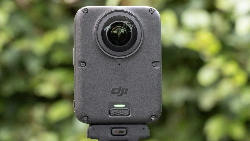 Rear view of the DJI Osmo 360 II showing its second fisheye lens, DJI logo and illuminated green status indicator.