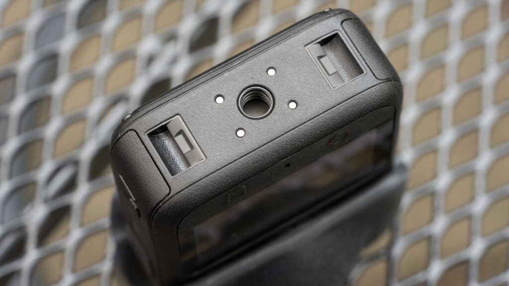 Close-up of the underside of the DJI Osmo 360 II showing its central threaded tripod socket and mounting slots.
