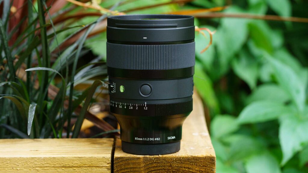 Left side (as you use it) of the Sigma 85mm f/1.2 DG Art mounted on a Sony camera, showing the AF/MF and aperture click switches on the lens barrel.
