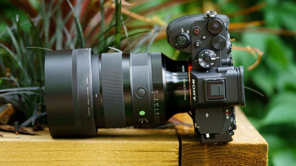 Sigma 85mm f/1.2 DG Art mounted on a Sony Alpha 7R VI, viewed from above with the lens hood, aperture ring and camera controls visible.