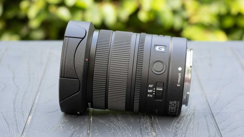 Side profile of the Sony FE 8-14mm F3.5 Fisheye G with hood fitted, showing the G badge, focus hold button and AF/MF/FH switch.