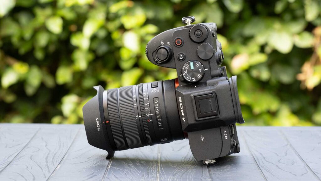 Sony FE 8-14mm F3.5 Fisheye G mounted on a Sony Alpha mirrorless camera, viewed from above with the camera controls visible.