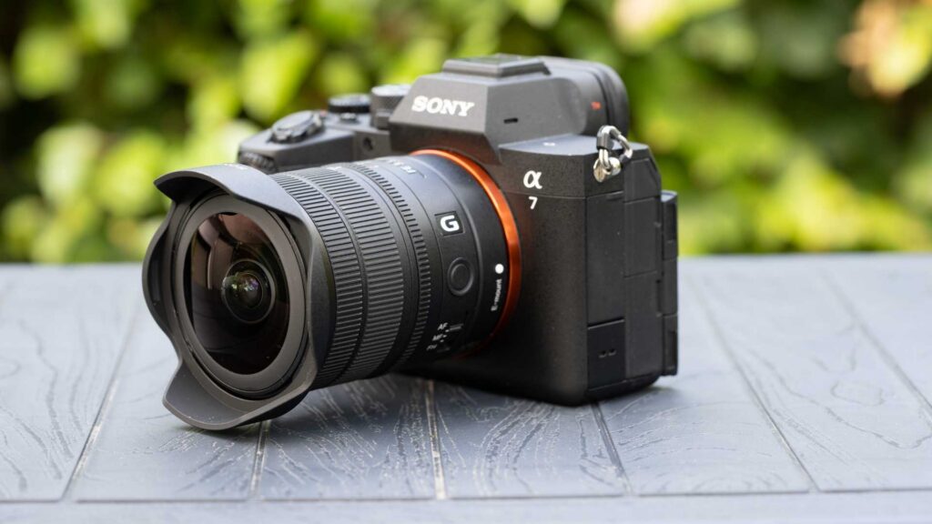 Three-quarter front view of the Sony FE 8-14mm F3.5 Fisheye G mounted on a Sony Alpha 7-series camera.