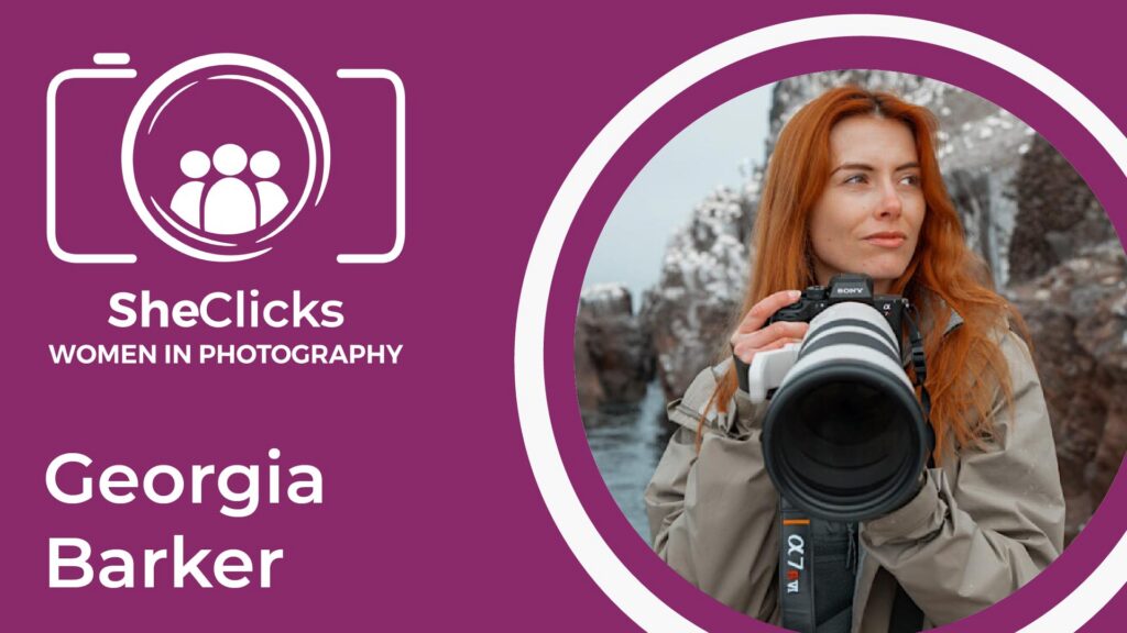 Burgundy SheClicks Women in Photography graphic featuring Georgia Barker’s name and a portrait of her holding a Sony camera with a long telephoto lens beside a rocky coastline.
