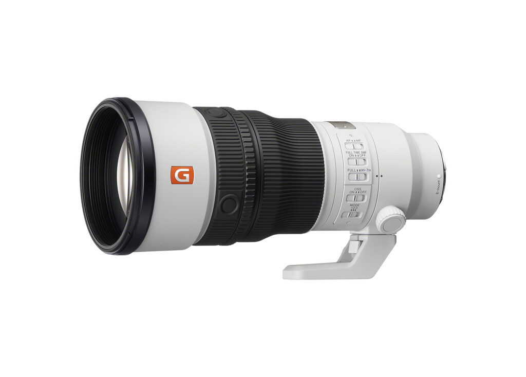 Side view of the white Sony FE 400mm F4.5 GM OSS telephoto lens, showing its focus and control rings, switches and tripod foot.