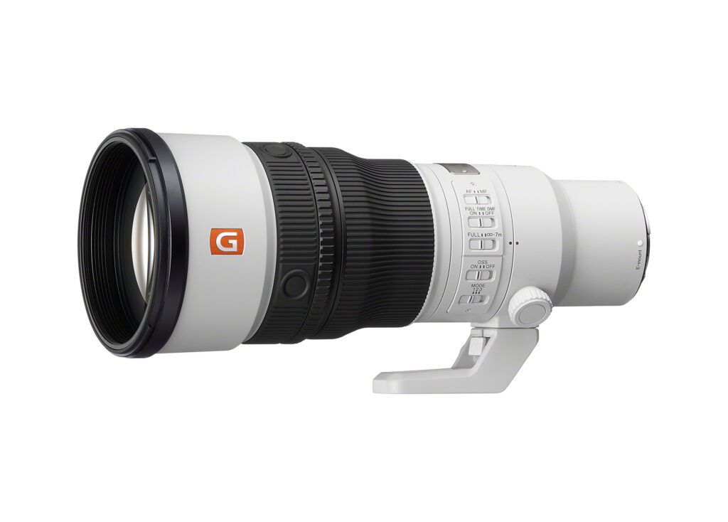 Side view of the white Sony FE 600mm F6.3 GM OSS telephoto lens, showing its focus rings, control switches and tripod foot.
